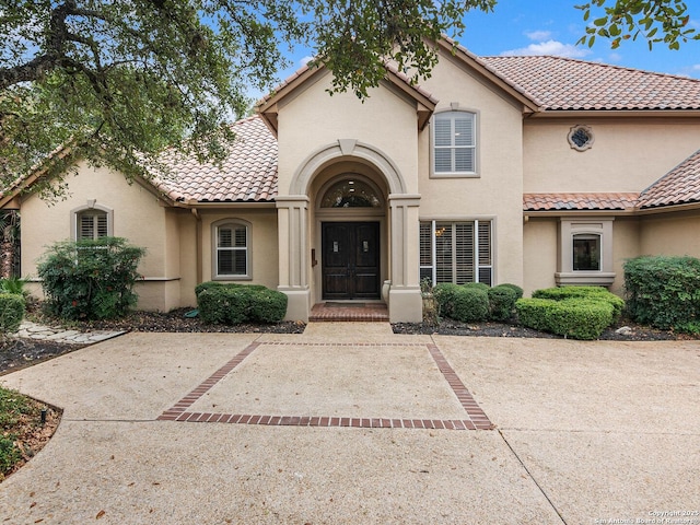 mediterranean / spanish house featuring a patio area