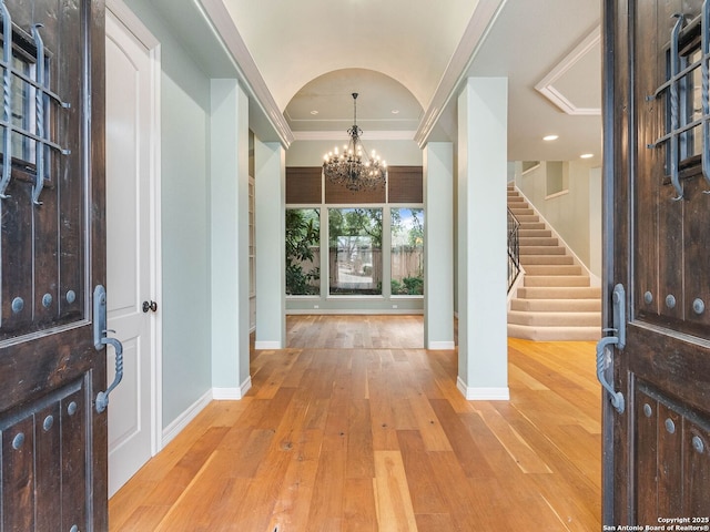 entryway featuring an inviting chandelier and light hardwood / wood-style floors