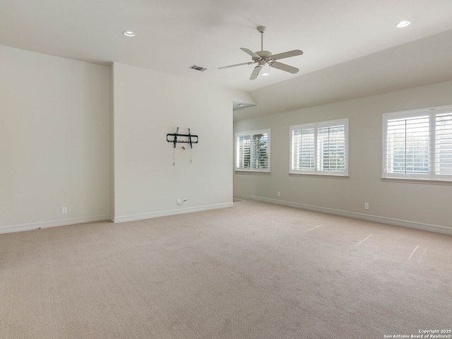 spare room with a healthy amount of sunlight, light carpet, and ceiling fan