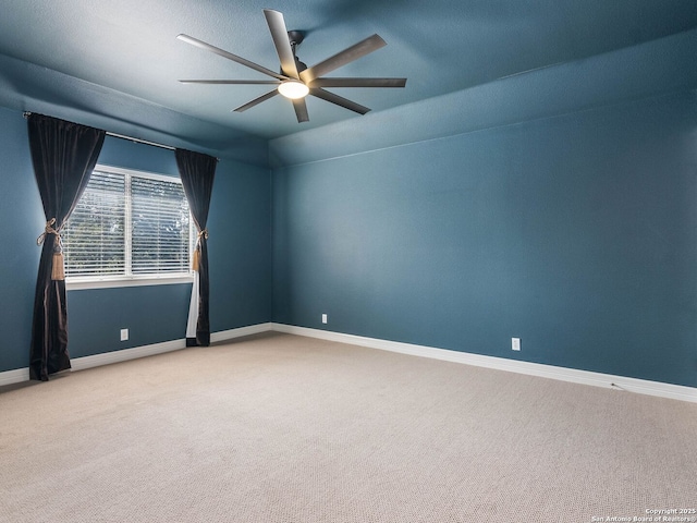 carpeted spare room featuring ceiling fan