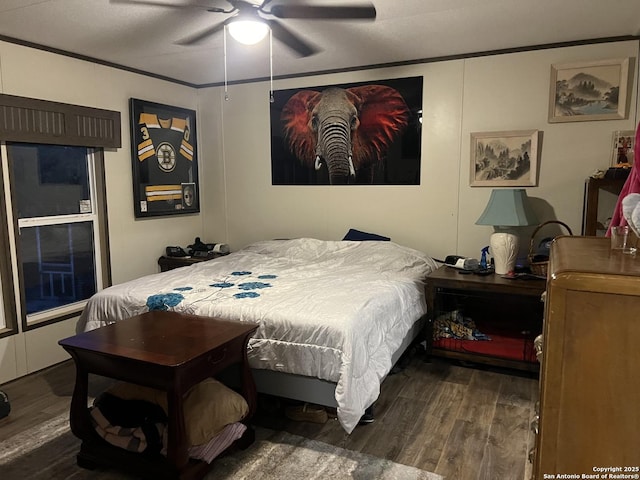 bedroom featuring hardwood / wood-style flooring, ceiling fan, and crown molding