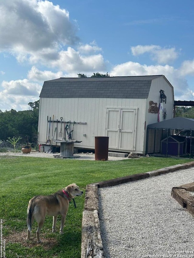 view of outbuilding featuring a lawn