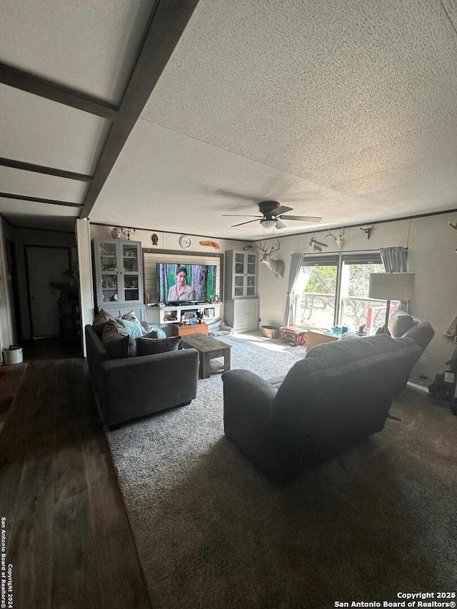 living room featuring a textured ceiling, ceiling fan, and wood-type flooring