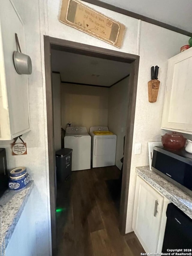 laundry area with washing machine and dryer and dark wood-type flooring