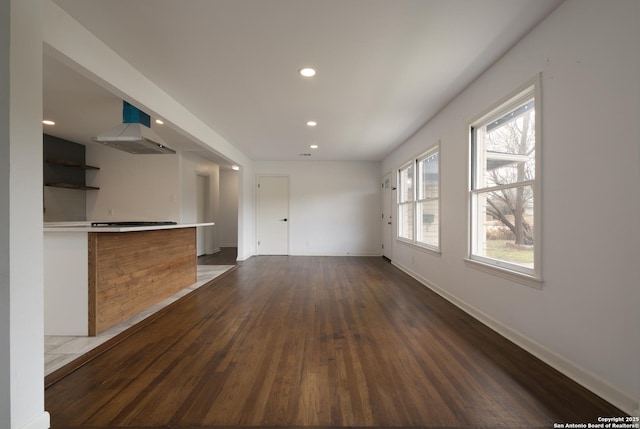 unfurnished living room with dark hardwood / wood-style flooring