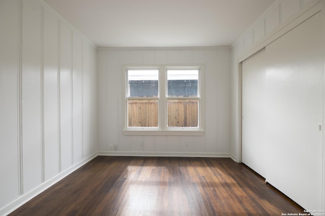 spare room featuring dark hardwood / wood-style flooring