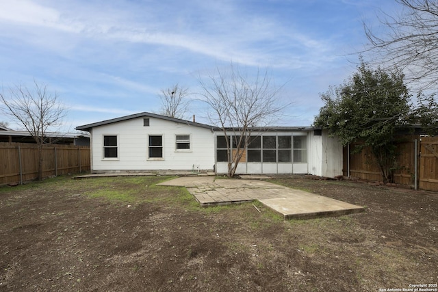 back of property featuring a sunroom and a patio area