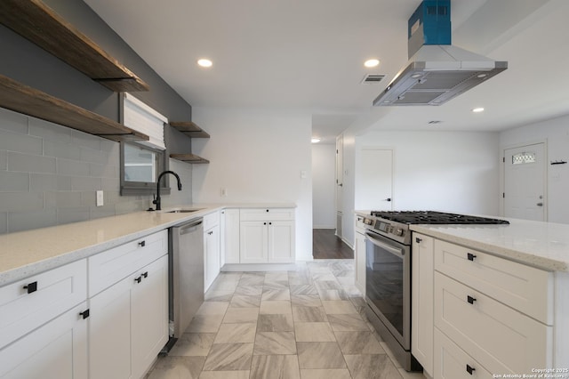 kitchen featuring sink, appliances with stainless steel finishes, light stone countertops, white cabinets, and island exhaust hood