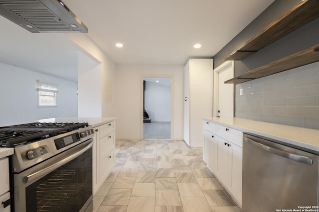 kitchen featuring white cabinetry, stainless steel appliances, and backsplash