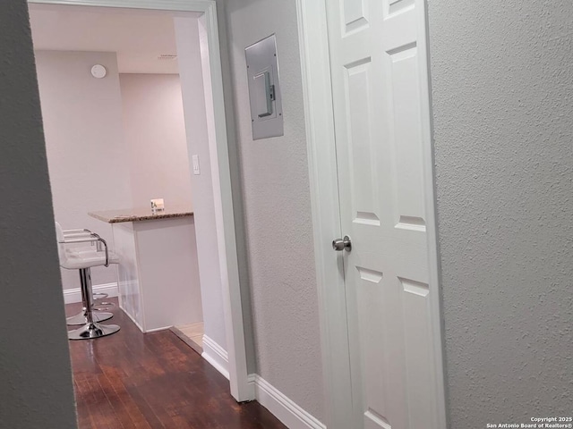 hall featuring dark hardwood / wood-style floors and electric panel