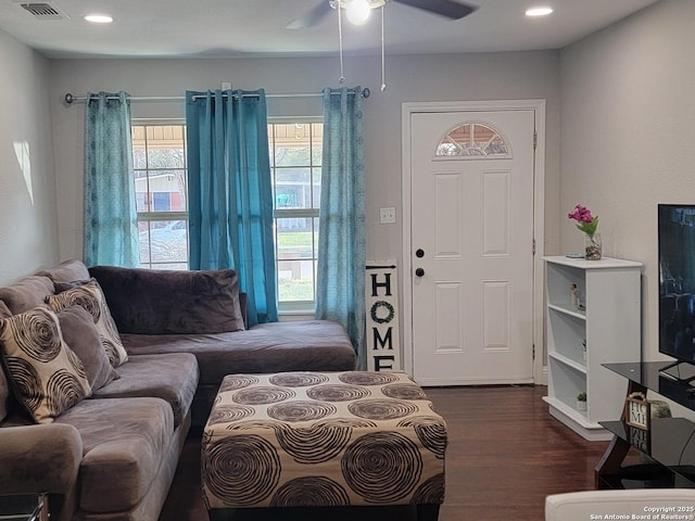 living room with dark wood-type flooring and ceiling fan