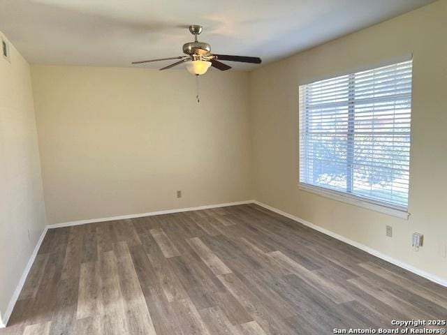 unfurnished room featuring ceiling fan and dark hardwood / wood-style flooring