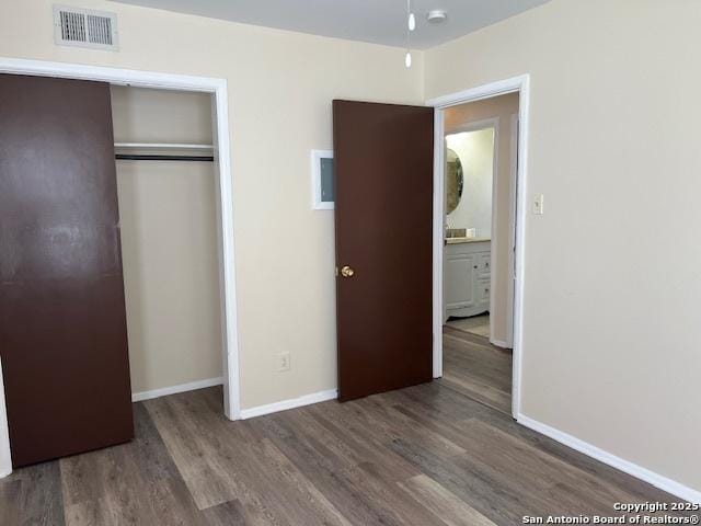 unfurnished bedroom with hardwood / wood-style floors and a closet