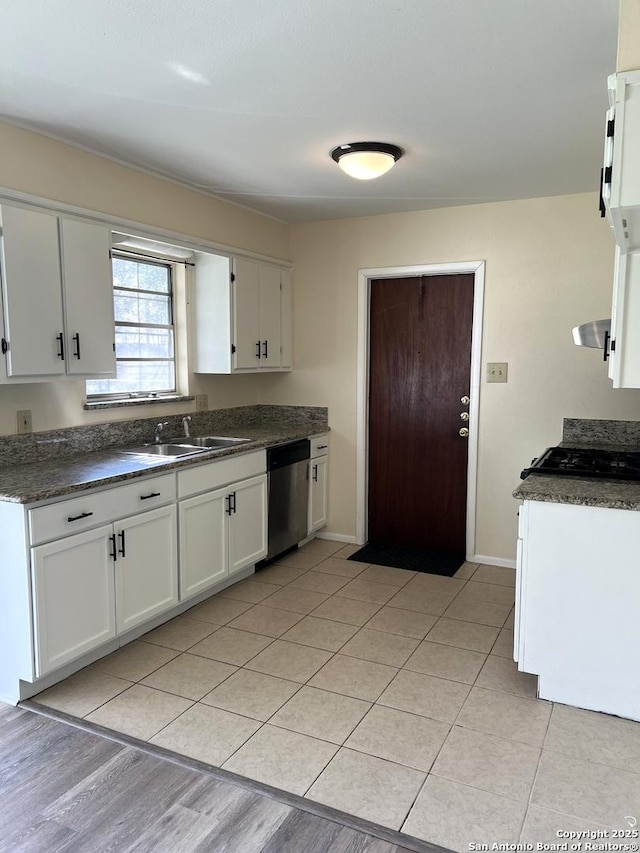 kitchen featuring sink, light tile patterned floors, dishwasher, range hood, and white cabinets