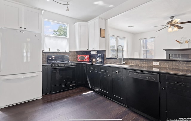 kitchen featuring sink, dark wood-type flooring, white cabinetry, black appliances, and decorative backsplash