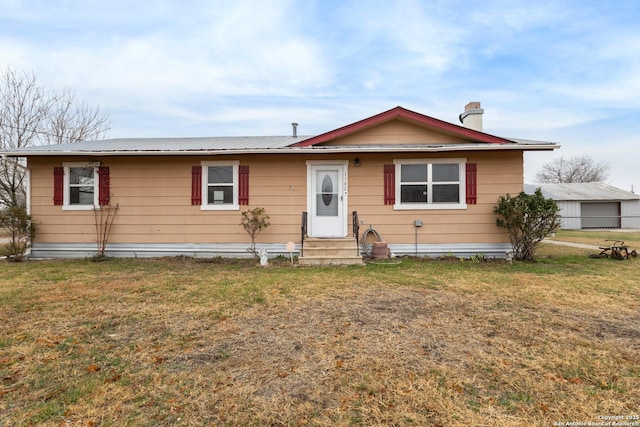 1102 Berlin St, Castroville, TX 78009 - view of front facade featuring entry steps, a chimney, and metal roof