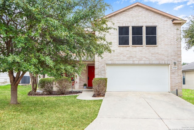 traditional-style home featuring a front yard, concrete driveway, brick siding, and an attached garage