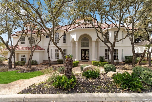 mediterranean / spanish-style house with french doors