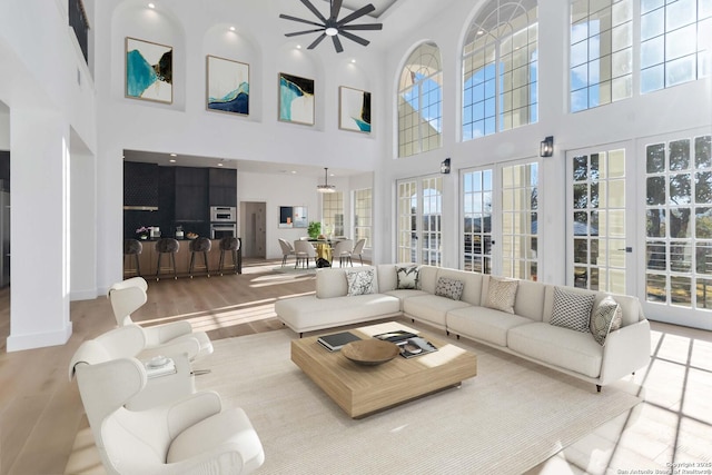 living room featuring ceiling fan and light hardwood / wood-style floors