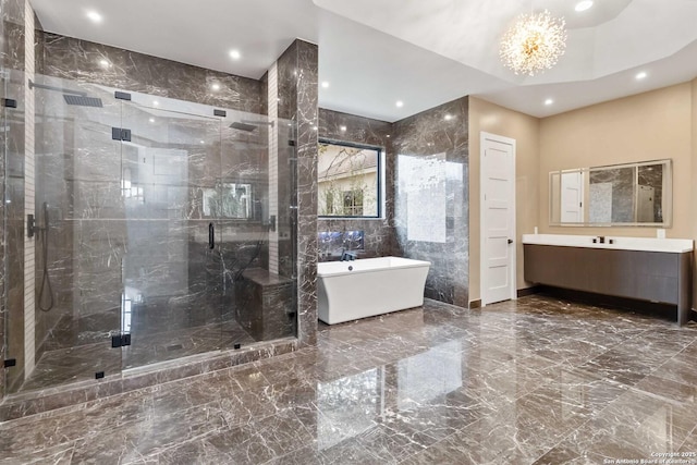 bathroom with vanity, separate shower and tub, and a notable chandelier