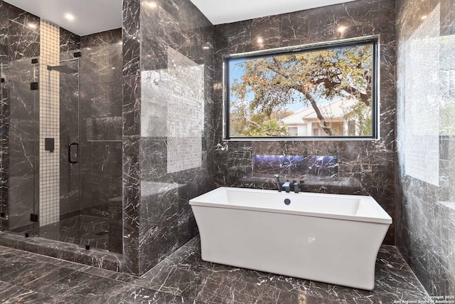 bathroom featuring separate shower and tub