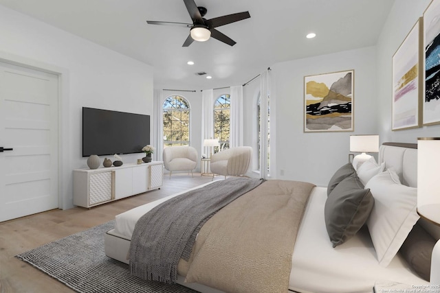 bedroom featuring hardwood / wood-style floors and ceiling fan