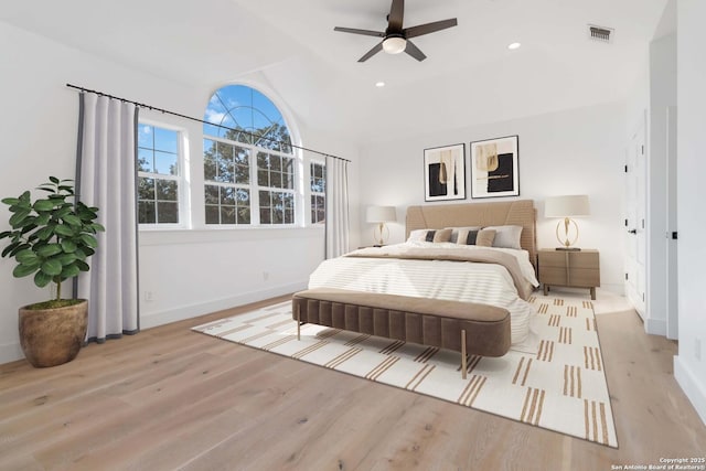 bedroom with vaulted ceiling, ceiling fan, and light wood-type flooring