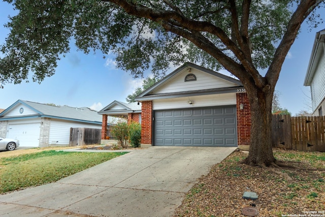 single story home featuring a garage and a front yard