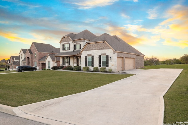 view of front of property featuring a garage and a yard