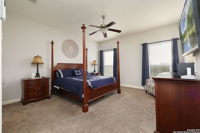 carpeted bedroom with multiple windows and ceiling fan