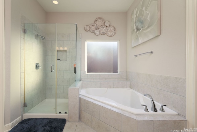 bathroom with tile patterned flooring and shower with separate bathtub