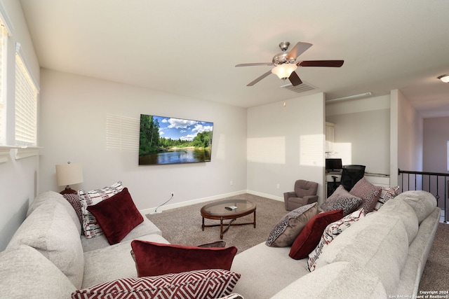 carpeted living room with ceiling fan