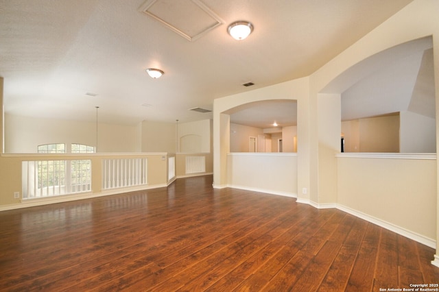 13906 Tahoe Vis, San Antonio, TX 78253 - unfurnished room with baseboards, visible vents, arched walkways, and hardwood / wood-style floors
