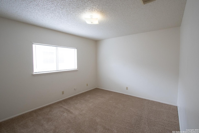 carpeted spare room featuring a textured ceiling