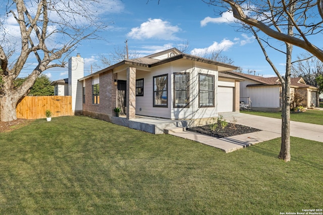 view of front facade with a garage and a front lawn