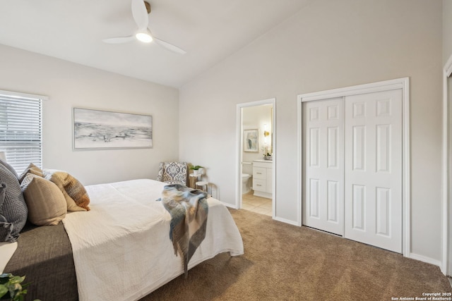 bedroom featuring lofted ceiling, ensuite bathroom, light colored carpet, a closet, and ceiling fan