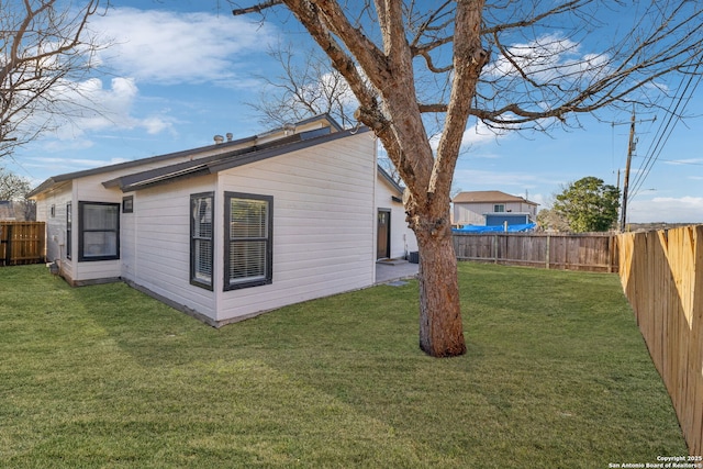 rear view of property with a lawn