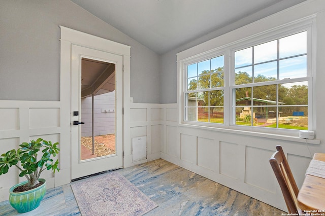 doorway to outside with hardwood / wood-style flooring, vaulted ceiling, and a wealth of natural light