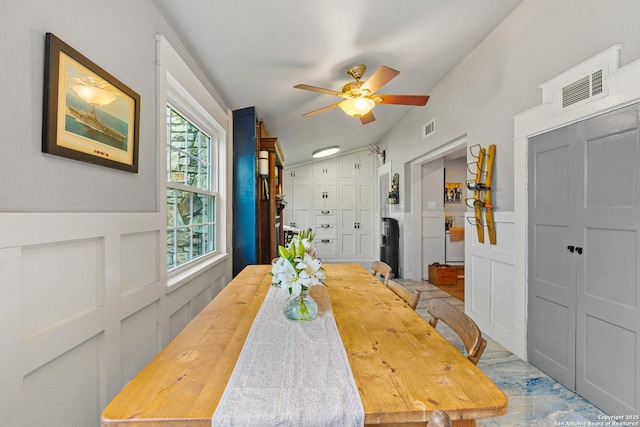 dining area featuring ceiling fan and lofted ceiling