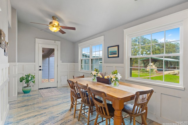 dining area featuring lofted ceiling, hardwood / wood-style floors, and ceiling fan