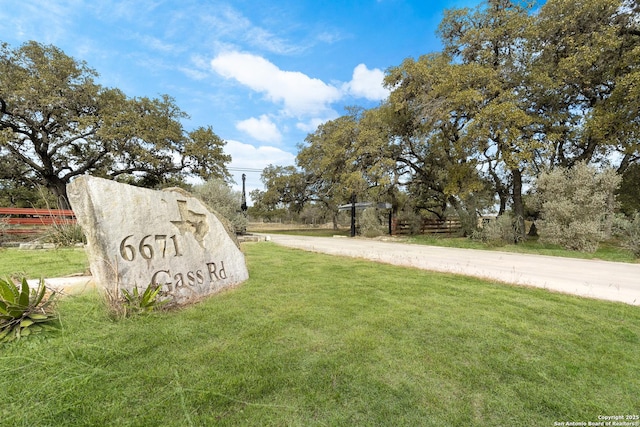 community sign featuring a lawn