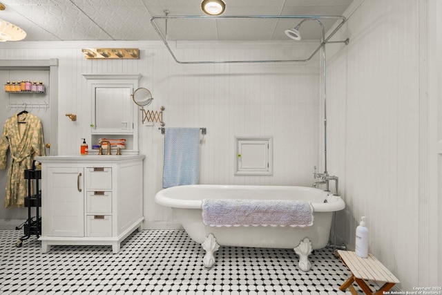 bathroom featuring vanity and a bath