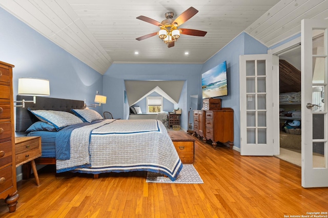 bedroom featuring vaulted ceiling, ceiling fan, wood ceiling, light hardwood / wood-style floors, and french doors