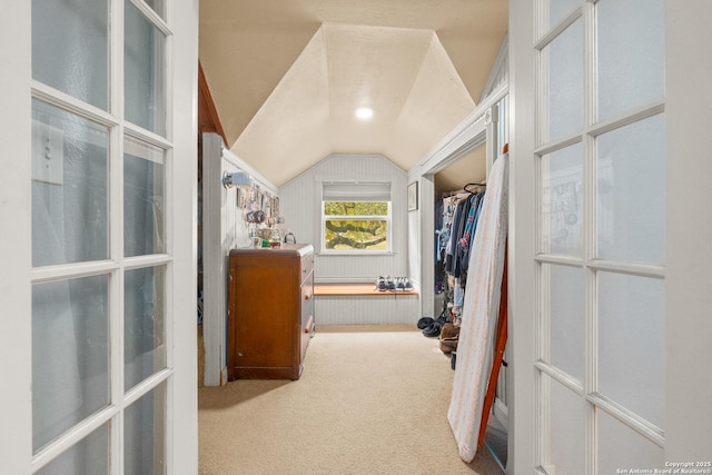 walk in closet featuring vaulted ceiling and carpet