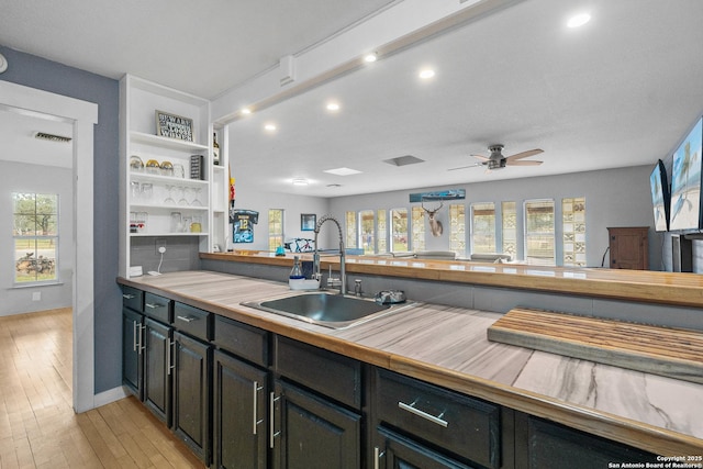 kitchen with sink, light hardwood / wood-style flooring, and ceiling fan