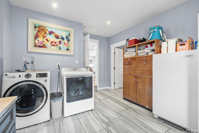 laundry room with washing machine and clothes dryer