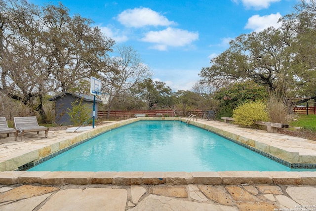 view of pool with a storage shed and a patio area