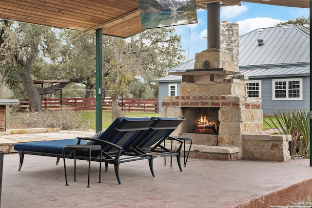 view of patio featuring an outdoor stone fireplace