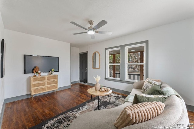 living room featuring dark hardwood / wood-style floors and ceiling fan