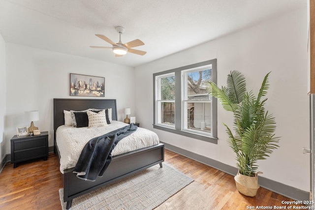 bedroom with hardwood / wood-style floors and ceiling fan